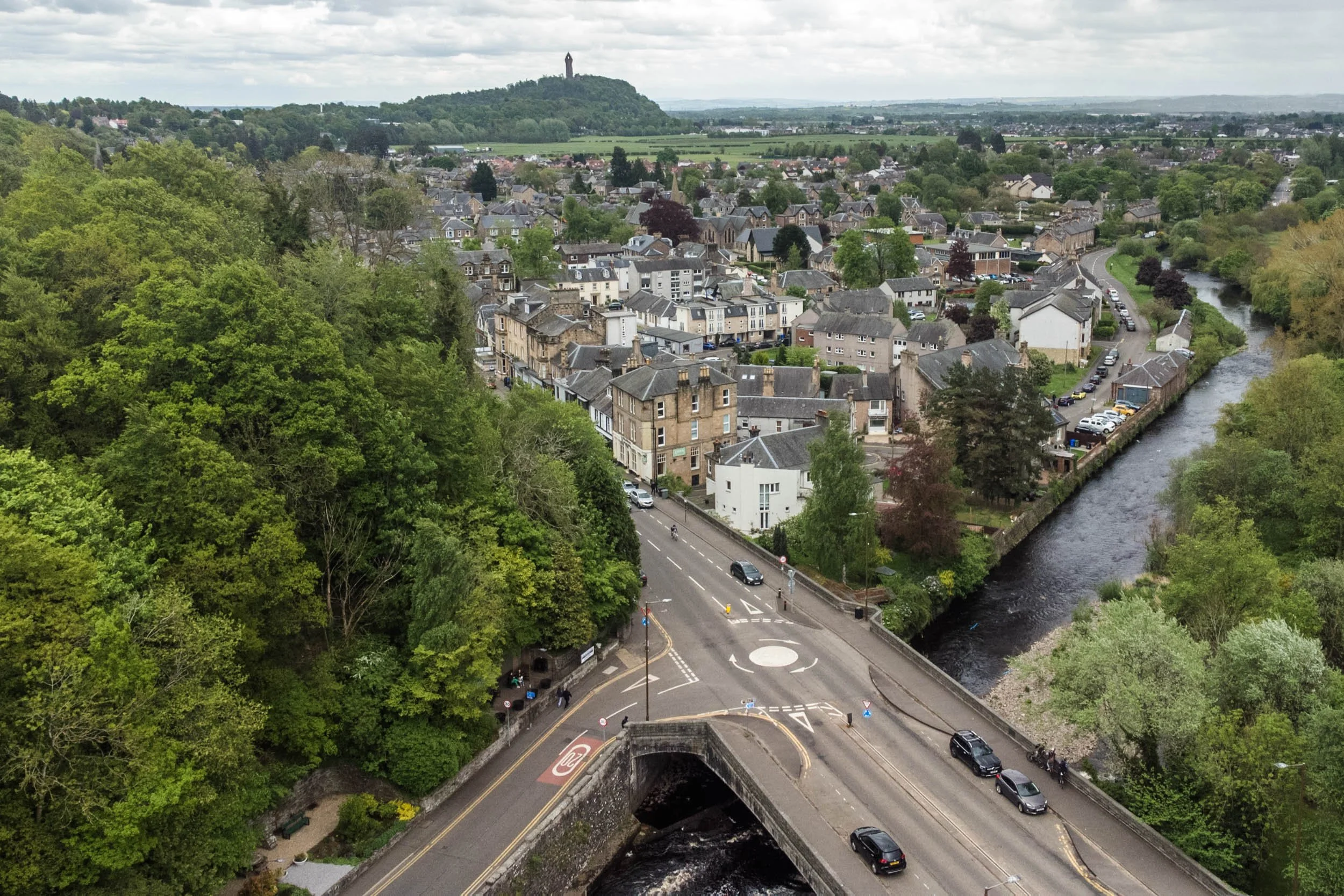 Aerial photo of Bridge of Allan showing the town and the Wallace Monument in the distance