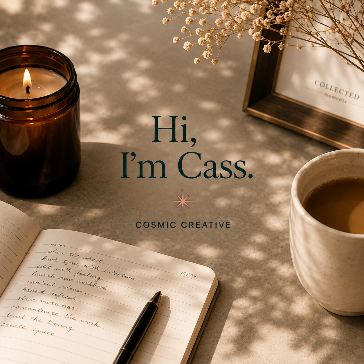 A flat lay of a workspace with a lit candle, a mug of coffee, an open notebook with handwritten notes, and a photo frame with dried flowers on a textured surface, with the text 'Hi, I’m Cass. Cosmic Creative' overlaid.