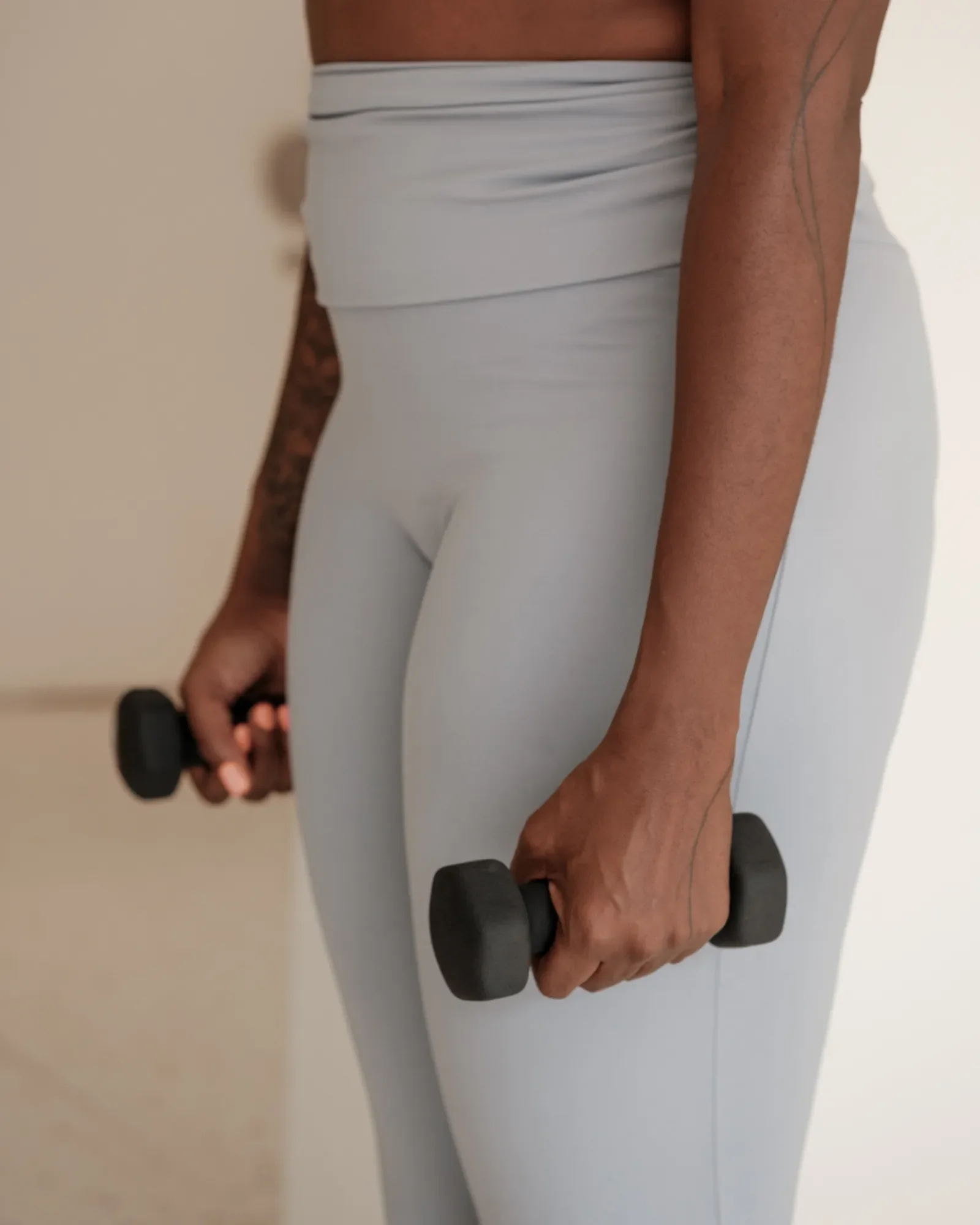 Woman holding small dumbbells in her hands