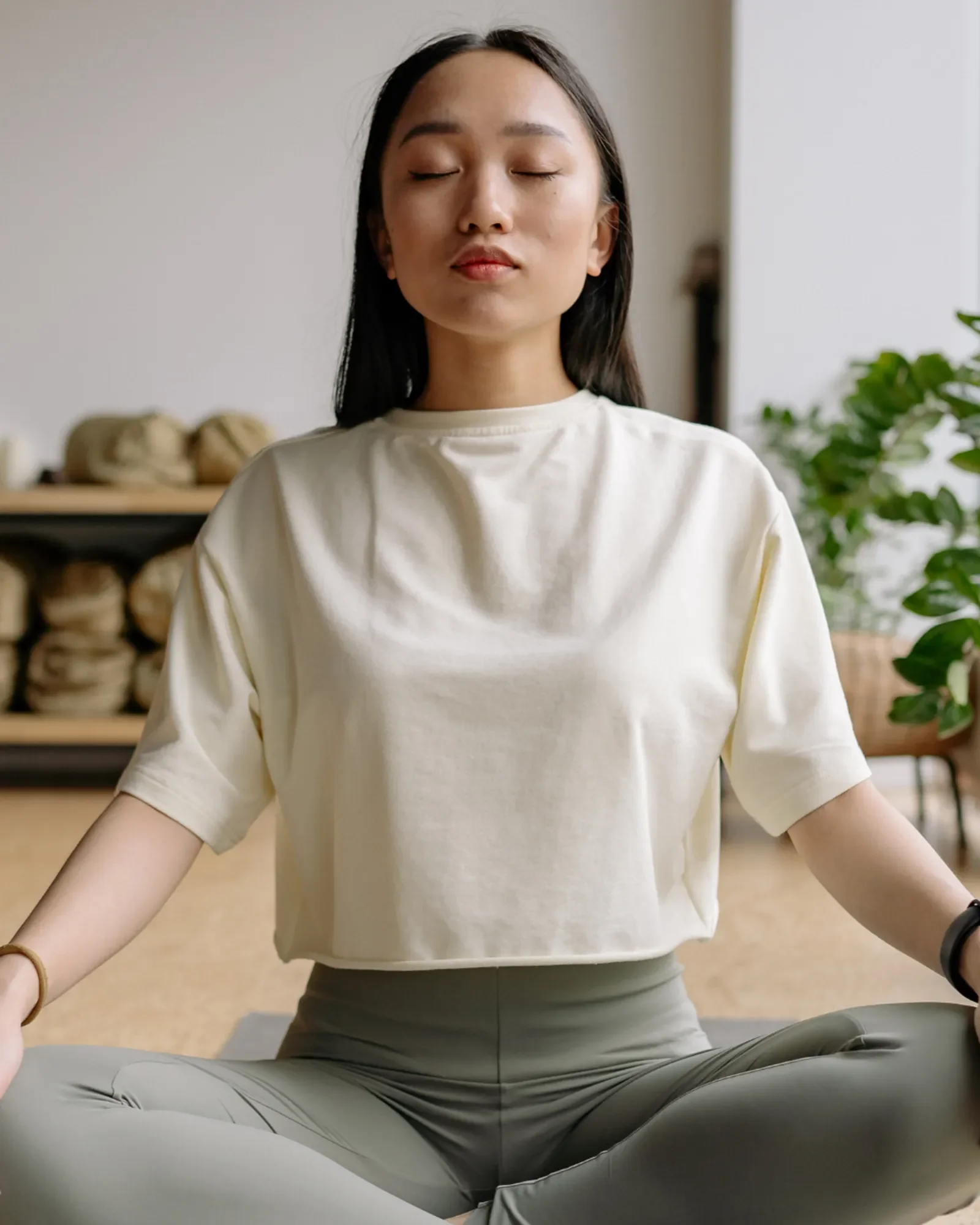 Woman sitting cross-legged and meditating