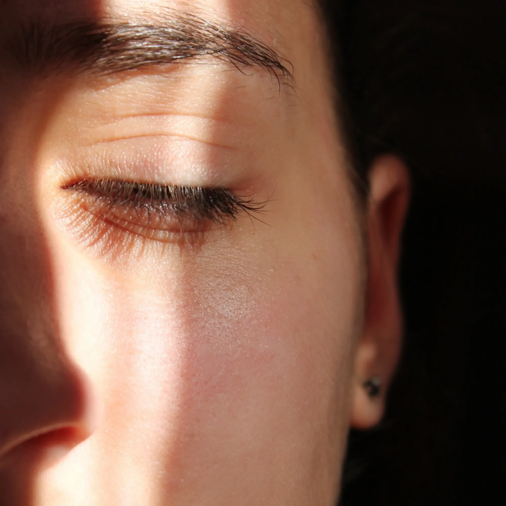 Close-up of a woman's face with her eyes closed