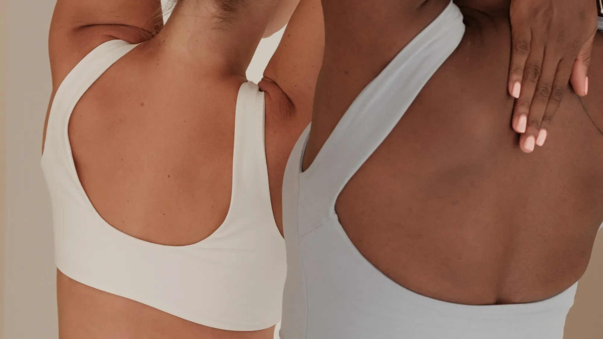 Two women stretching next to one another