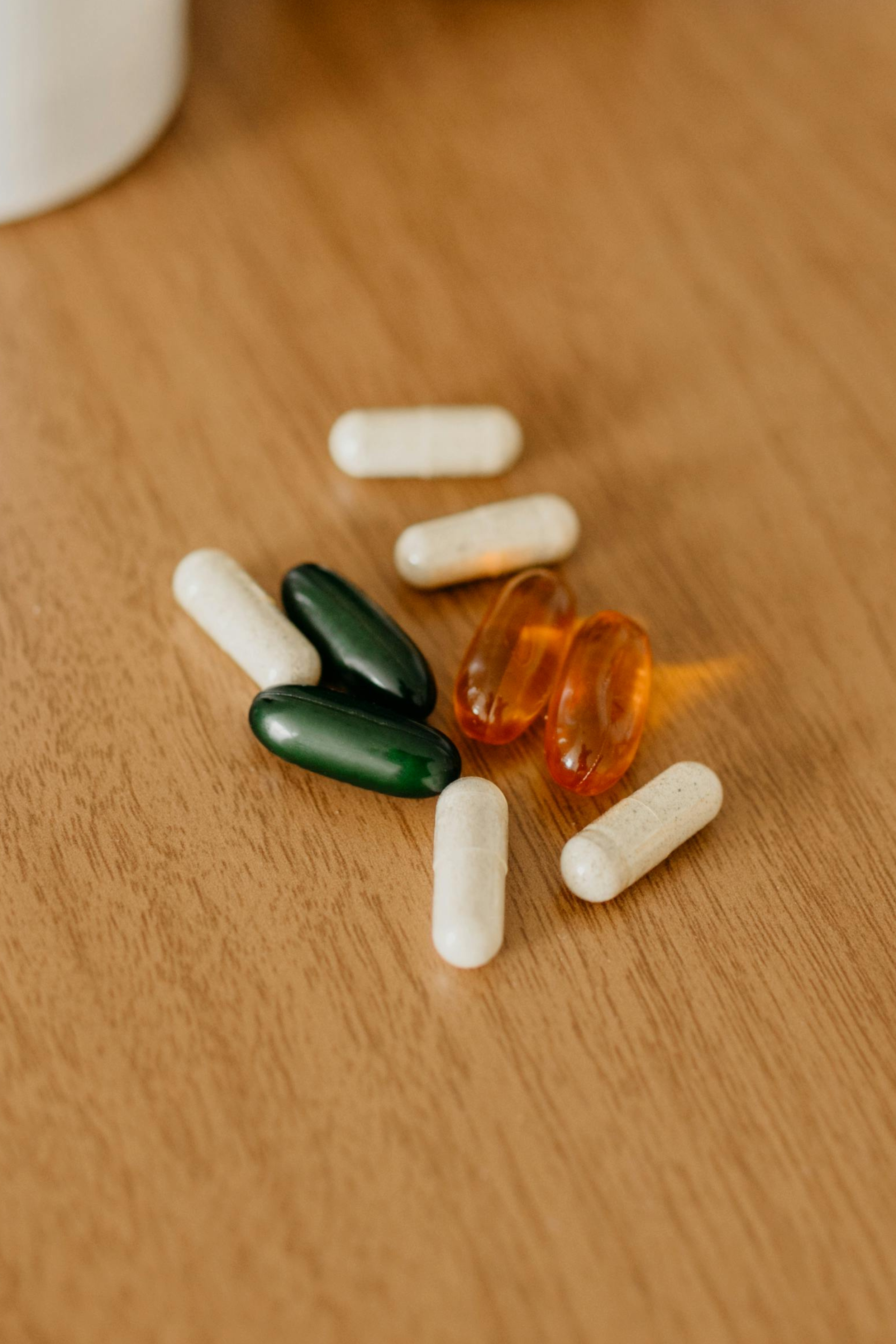 A cluster of vitamins on a wood table