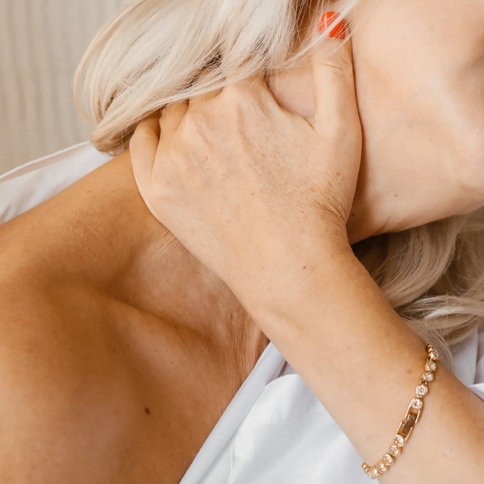 Elderly woman wiping her neck