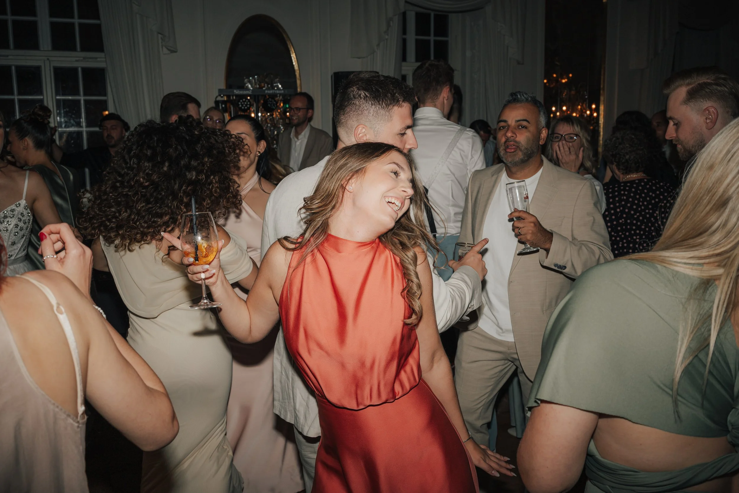 Guests celebrating on the dance floor during a luxury wedding reception photographed by Europe wedding photographer Änna Photography.