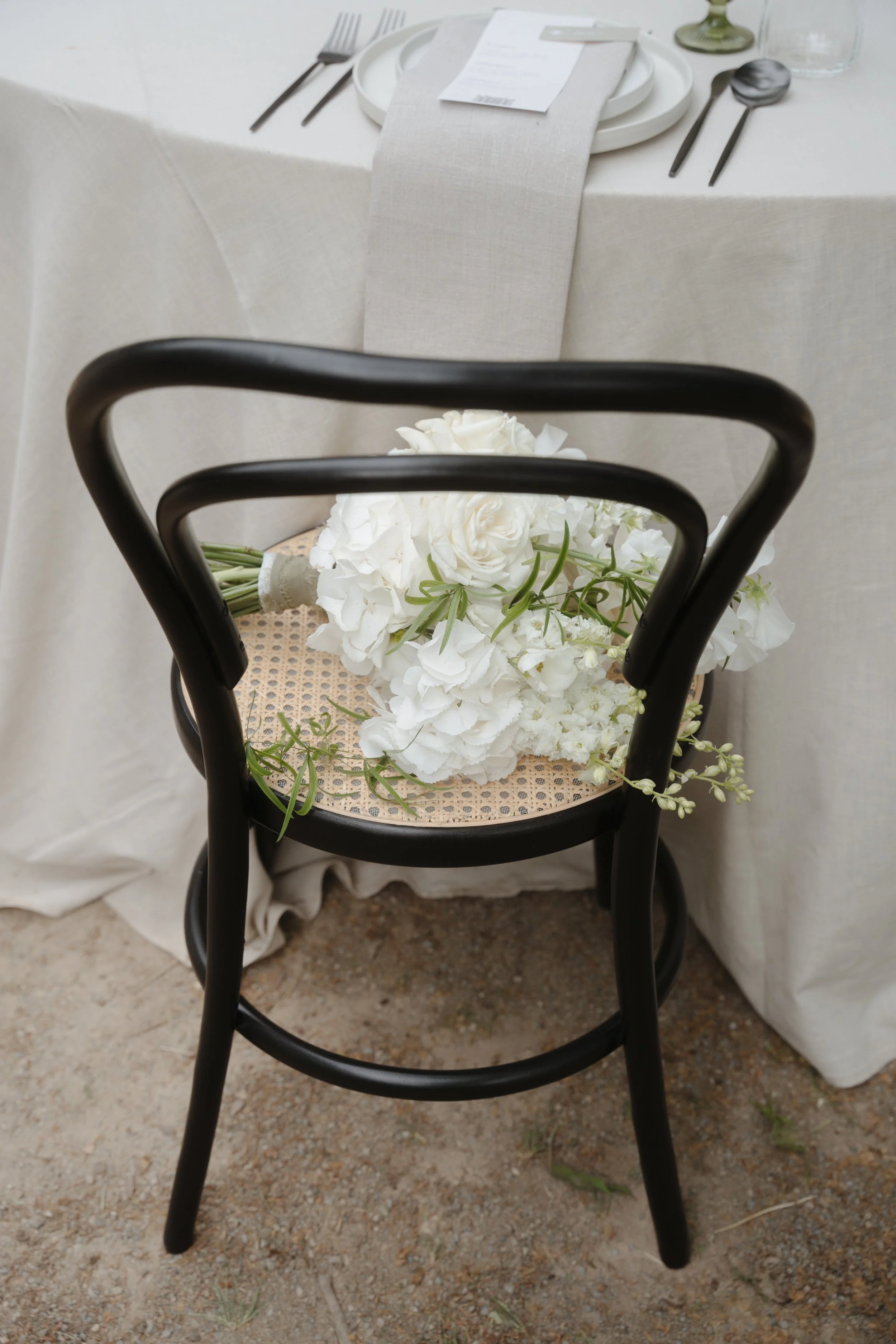 Wedding reception chair decorated with floral details, captured by editorial wedding photographer Änna Photography.