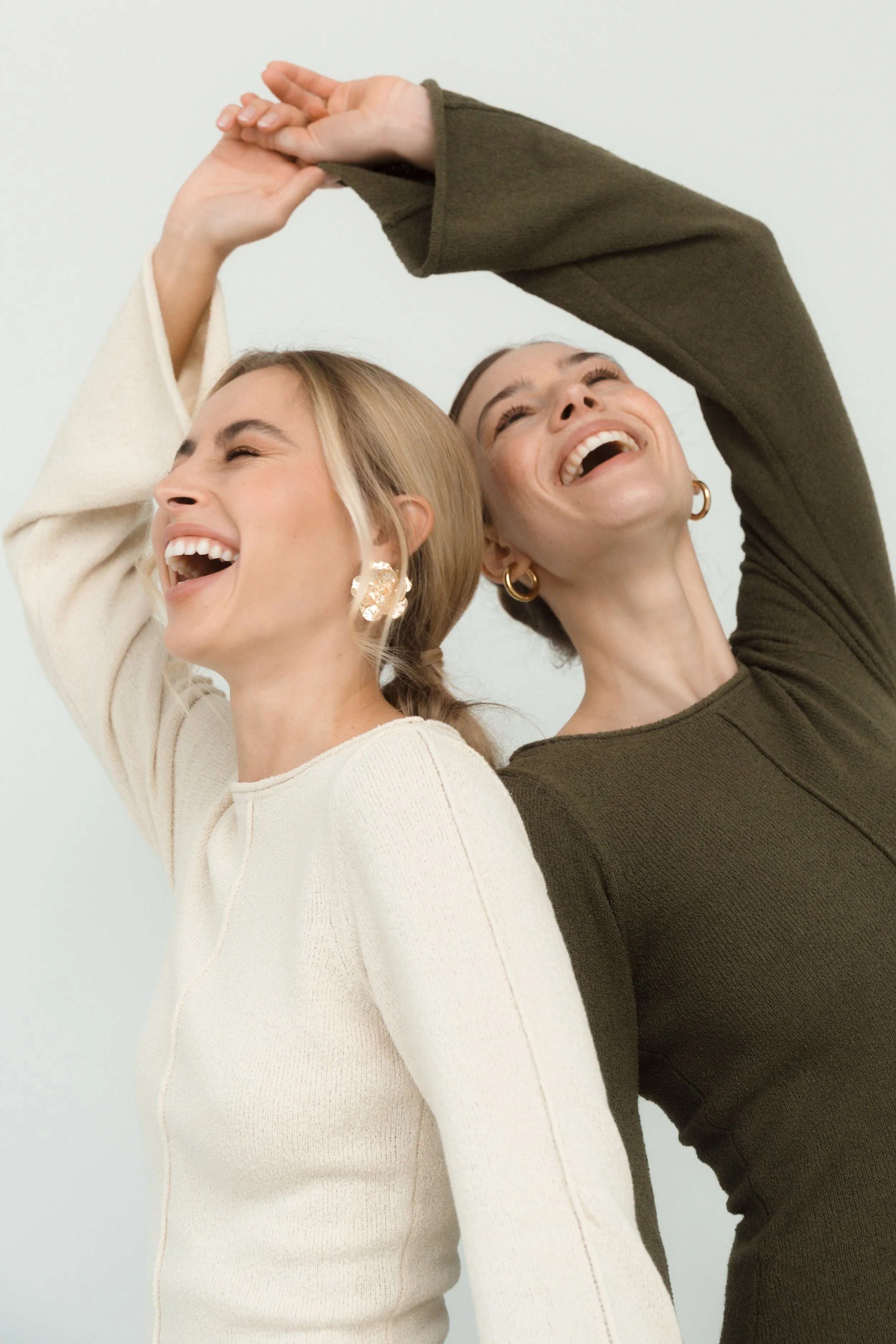 Authentic personal branding portrait of two women captured in a natural studio setting by Änna Photography.