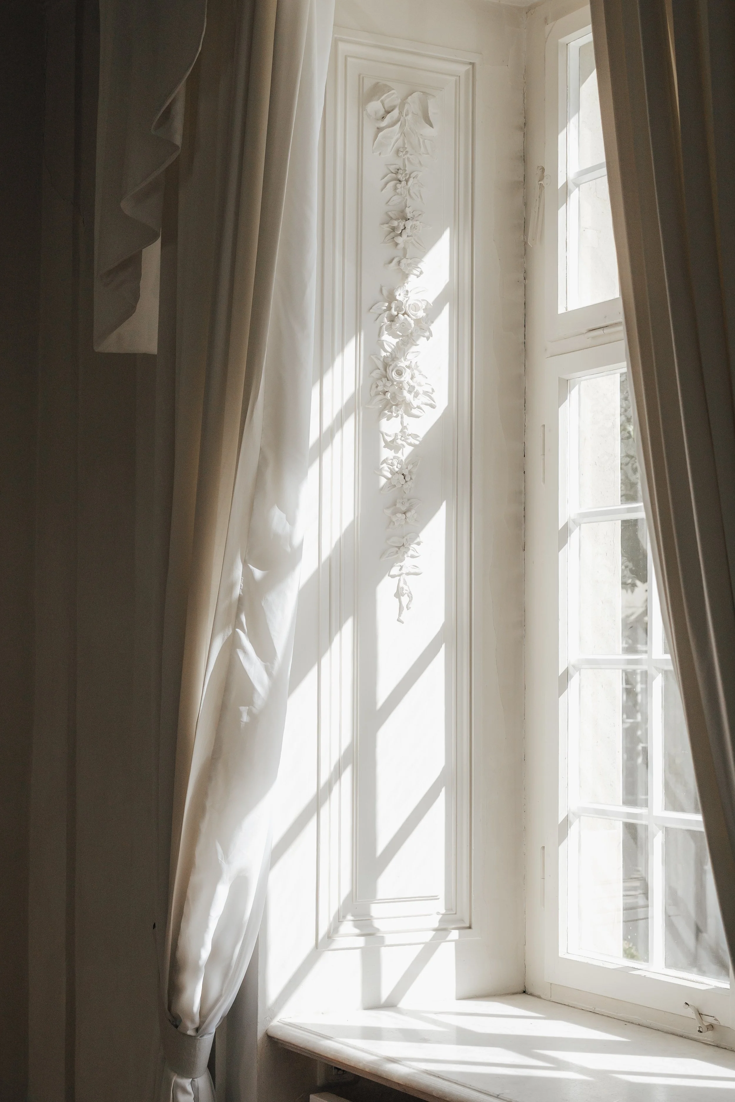 Soft natural light streaming through historic palace windows during an editorial wedding shoot.