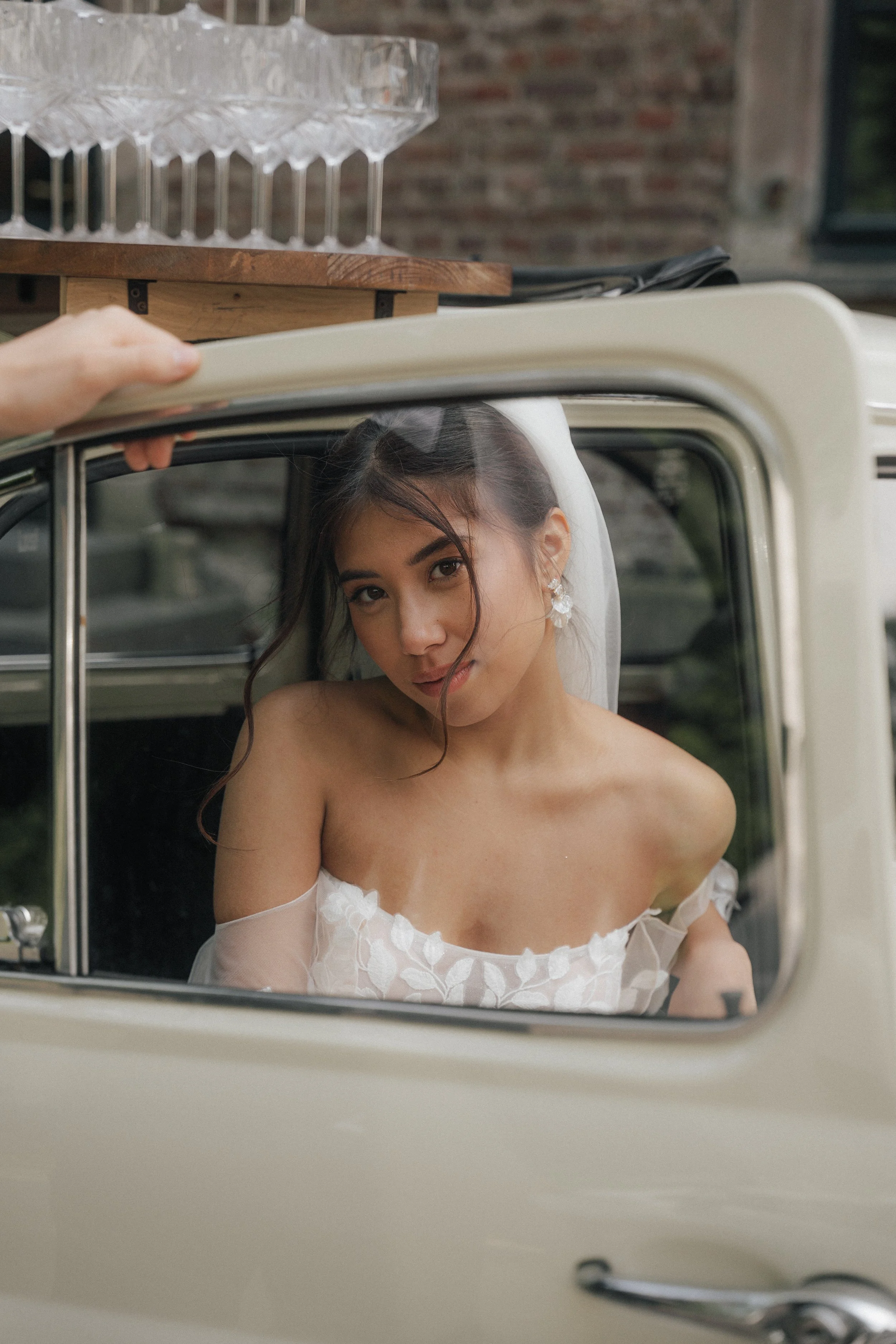 Editorial bridal portrait inside a vintage wedding car, captured by luxury wedding photographer Änna Photography.