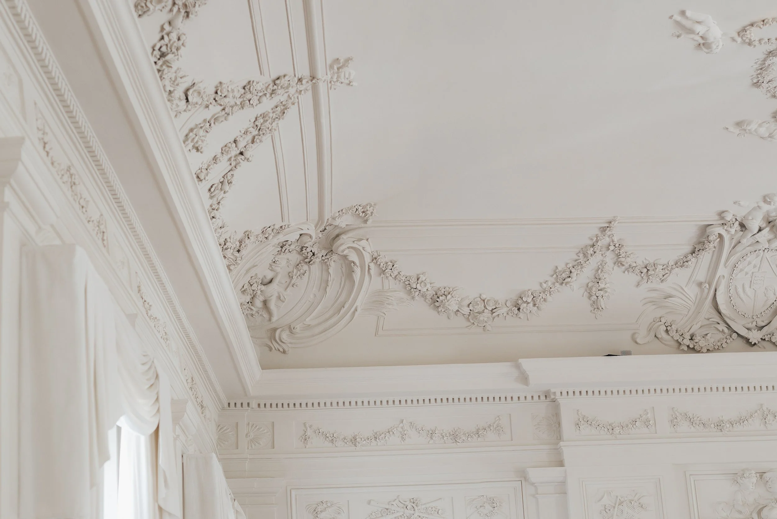 Historic palace ceiling with elegant architectural details at a luxury wedding venue in Europe.