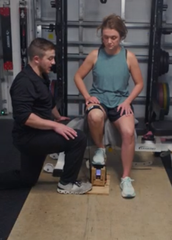 Matt Bailey, DPT, performing a knee movement assessment on a client during a physical therapy evaluation at A.I.R. Performance in Land O' Lakes