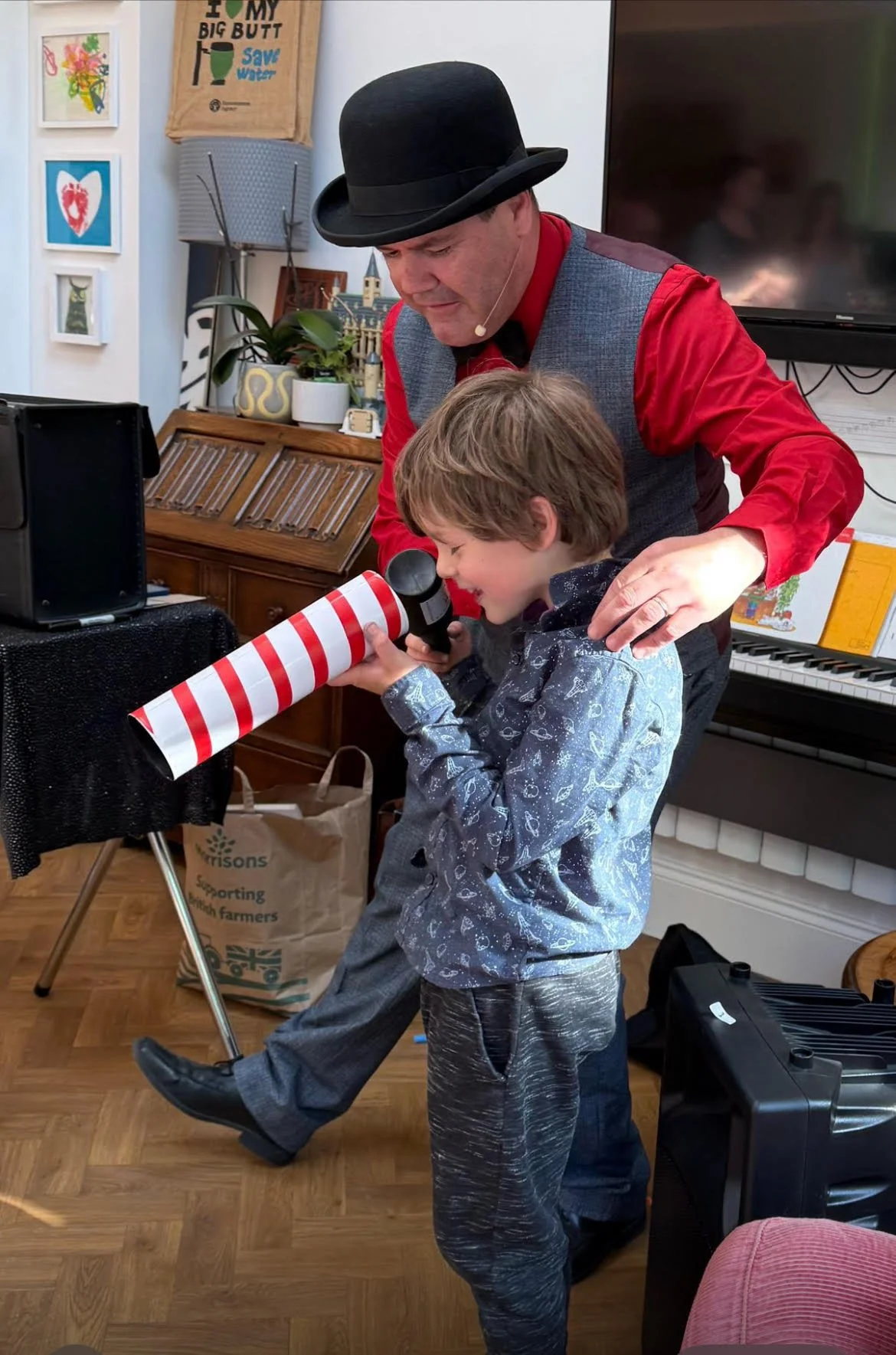 magician helps assistant with magic tube