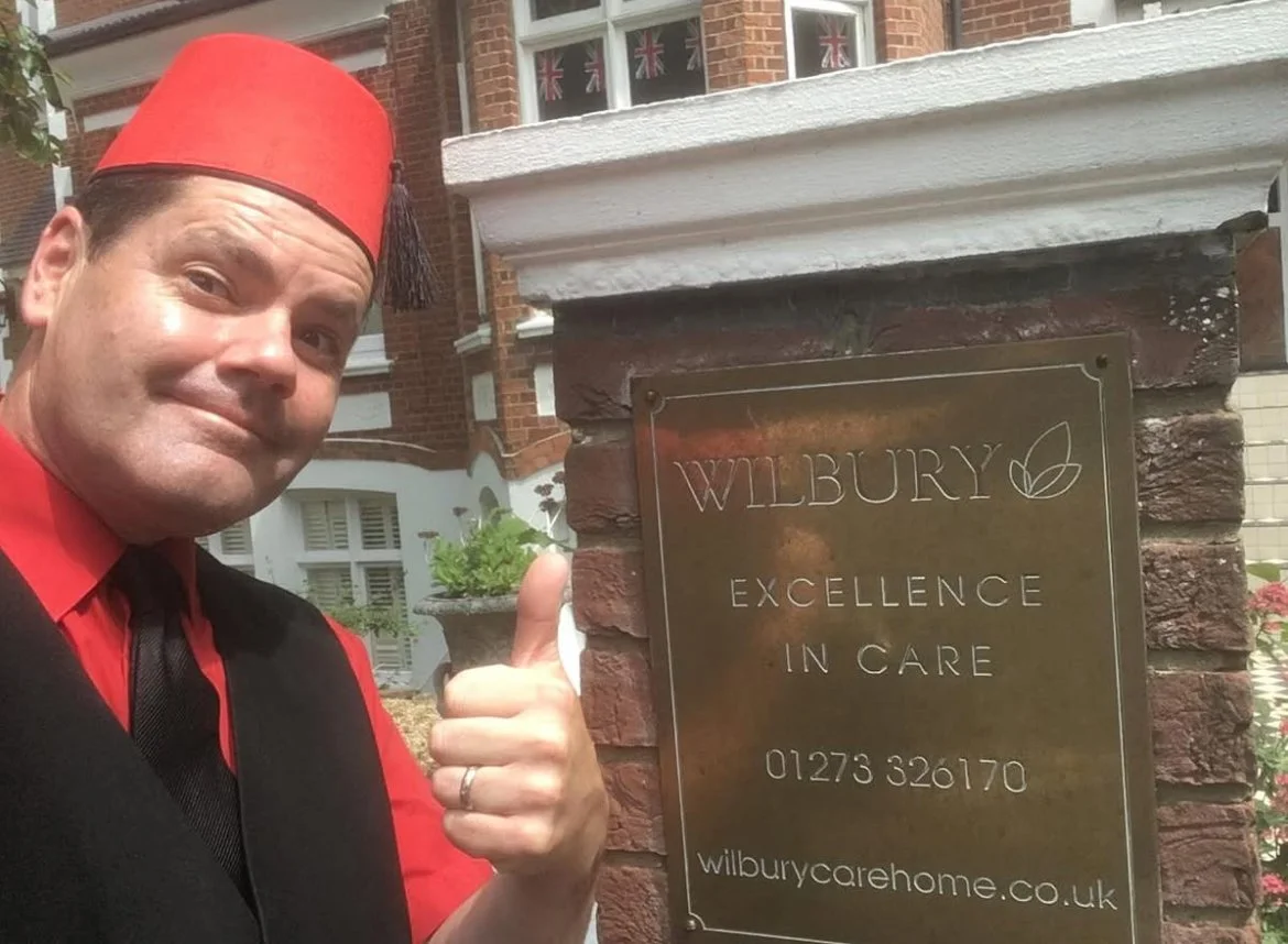 Magician David Croucher outside Wilbury Care Home