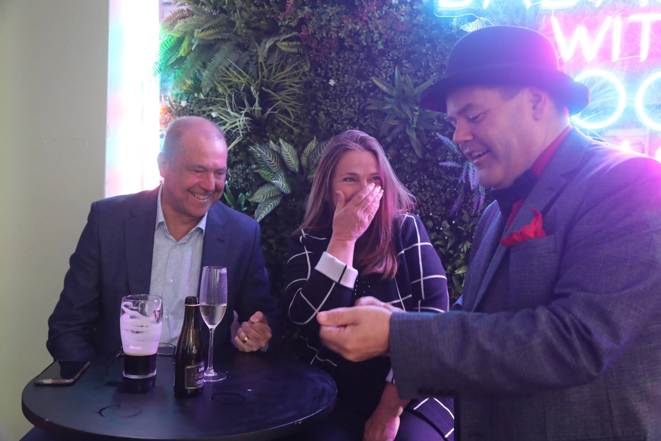 David Croucher entertains a lady at a party with close up magic