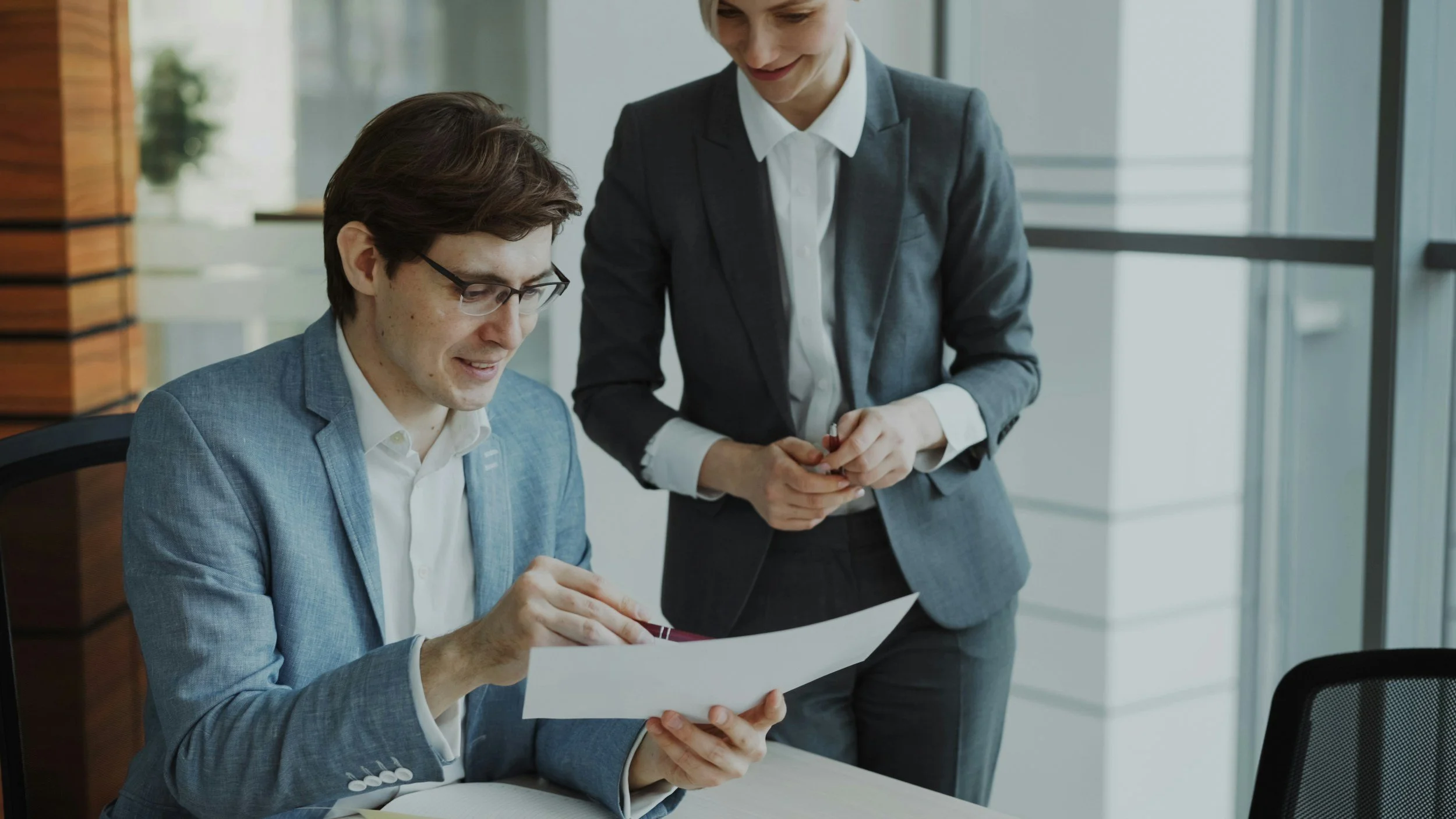 An experienced fractional CFO or COO acting as a strategic co-pilot, reviewing a monthly strategic report with a startup founder and leadership team.