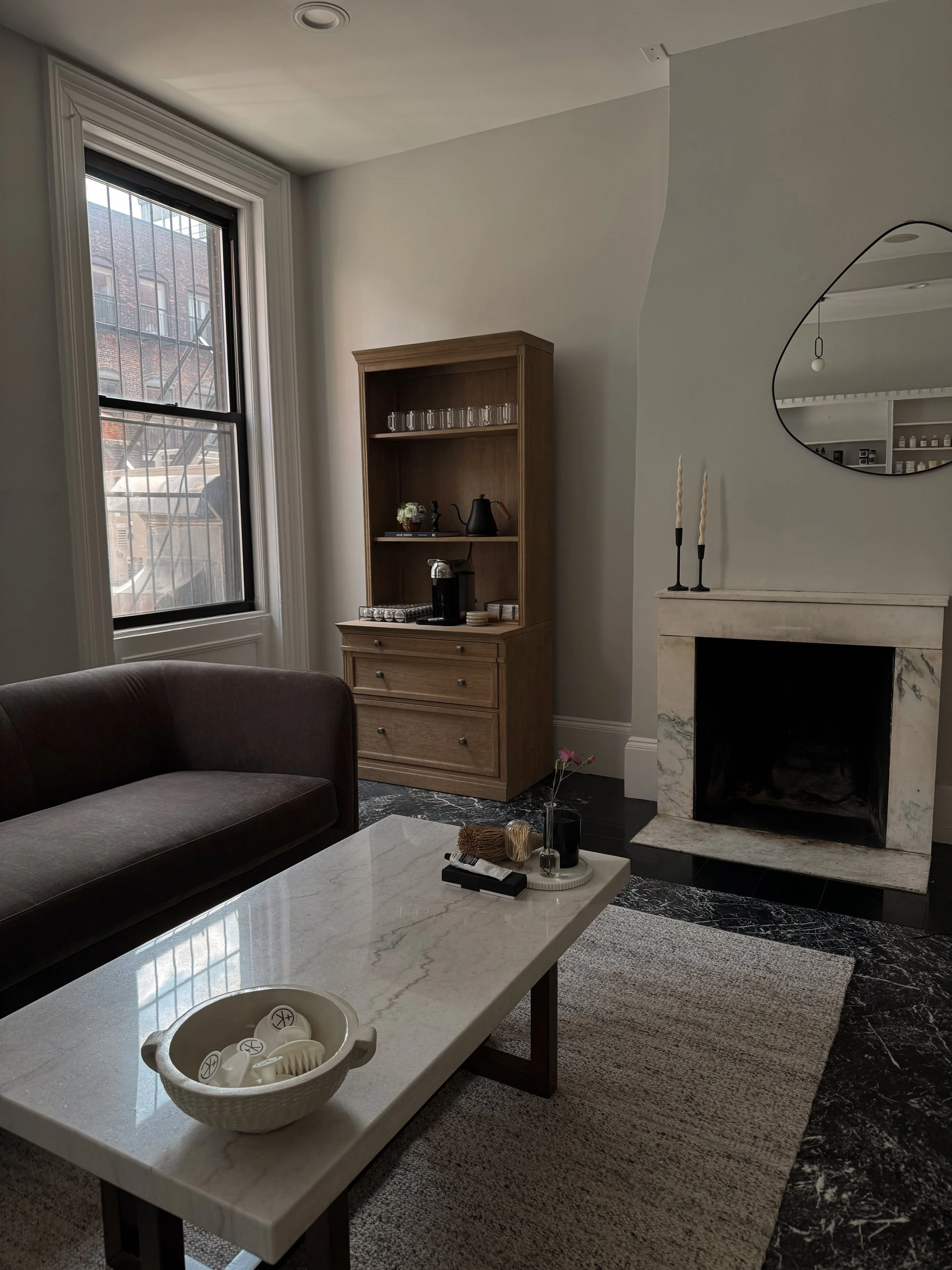 Boston brownstone hair salon, fireplace welcoming guests with coffee bar