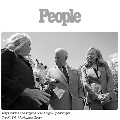 King Charles and Virginia Governor Abigail Spanberger with Tracy Bloom holding a lamb during an outdoor event.