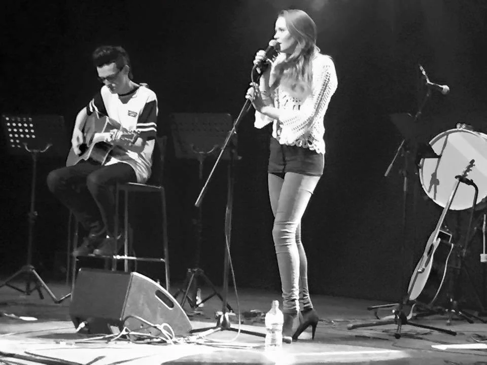 Kay Acoustic acoustic duo performing on a theatre stage in black and white, showcasing live wedding and event entertainment.