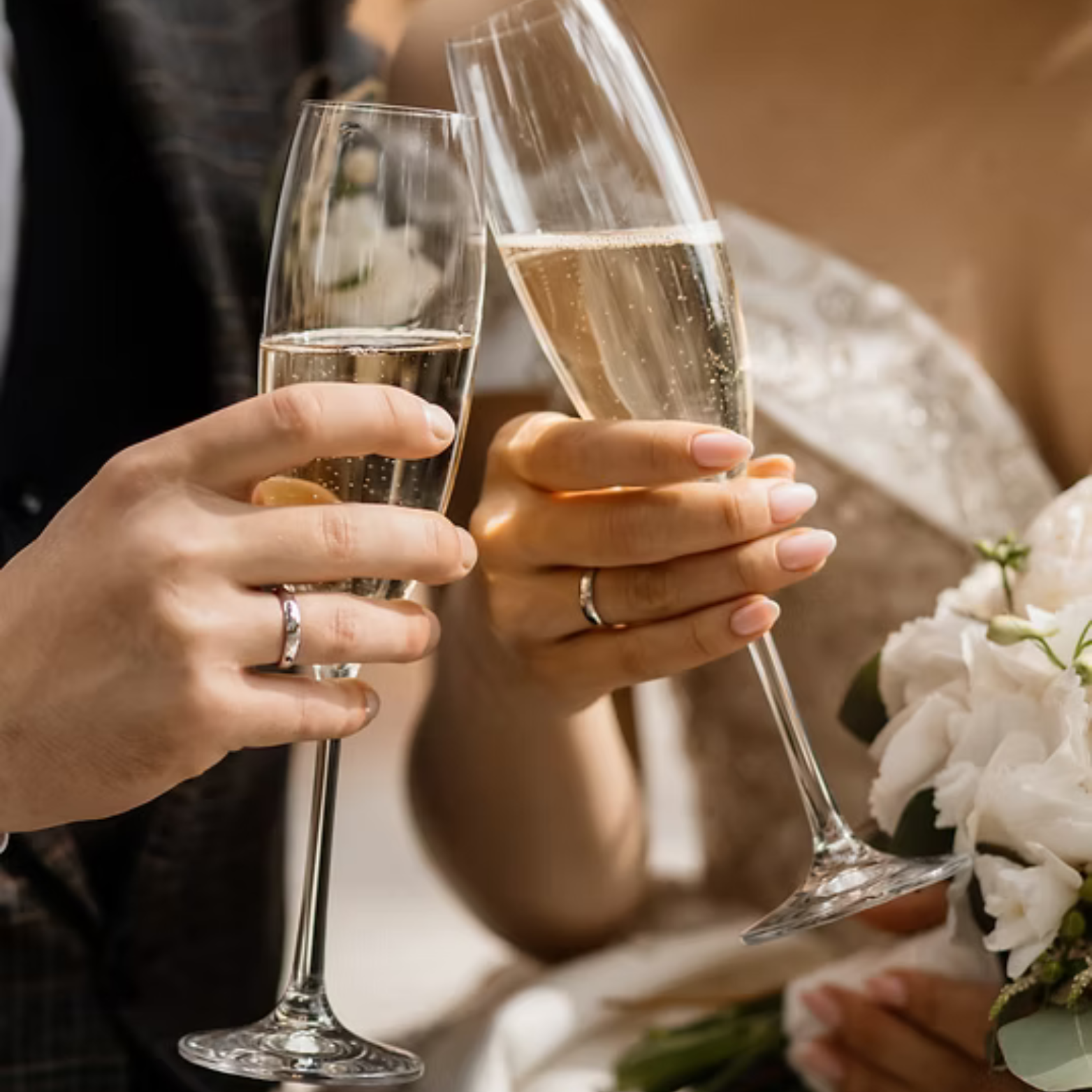 Bride and groom celebrating during their wedding drinks reception toasting champagne with live acoustic music by Kay Acoustic.