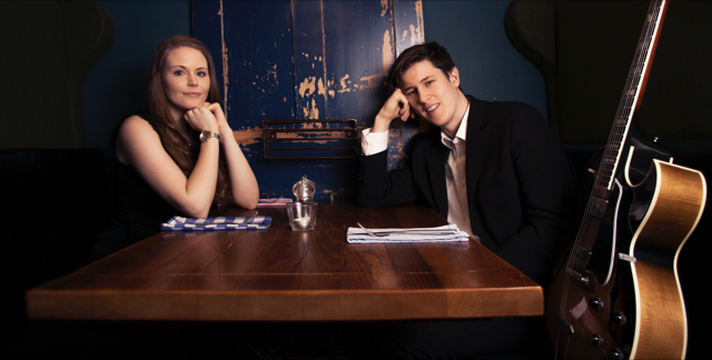 Kay Acoustic promotional photo of acoustic duo performers with guitar in a stylish UK venue for weddings, private parties and corporate events.