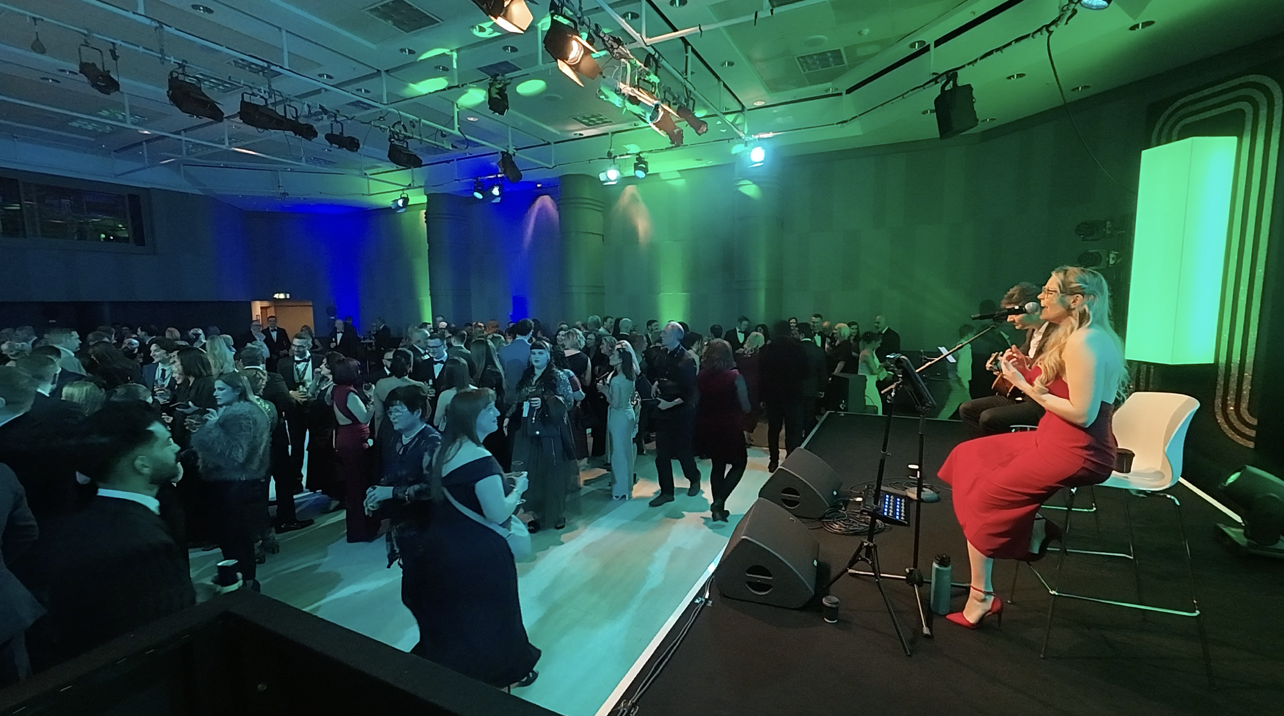 Kay Acoustic performing live at the ICC Birmingham for a Specsavers corporate event in 2026, entertaining hundreds of guests with acoustic live music and professional female vocals.