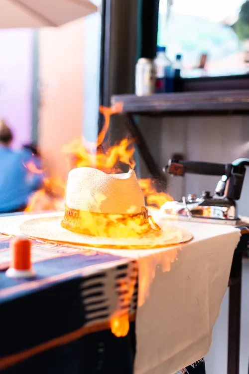 A hat catching fire on a table at an event.