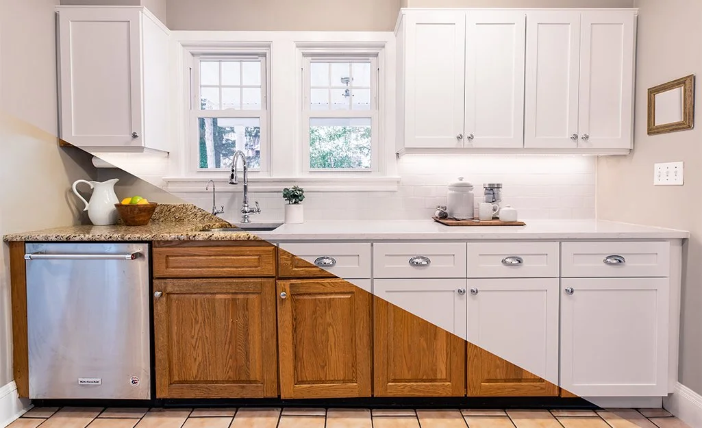 Kitchen with white and wood cabinets, two windows, stone countertop, stainless steel dishwasher, decor items, and a tiled floor.
