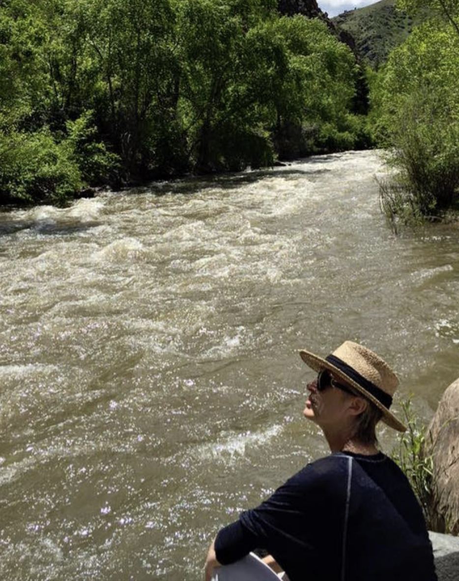Trina Wacasey VSED MAiD Death Doula with The Death Network sitting by a river contemplating life, death and everything in between