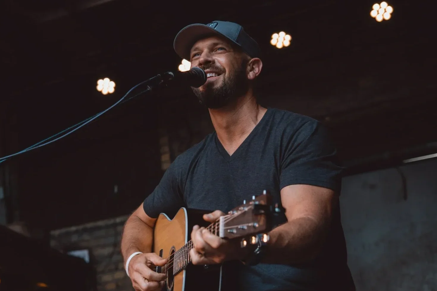 Dustin Becker performing live music on stage