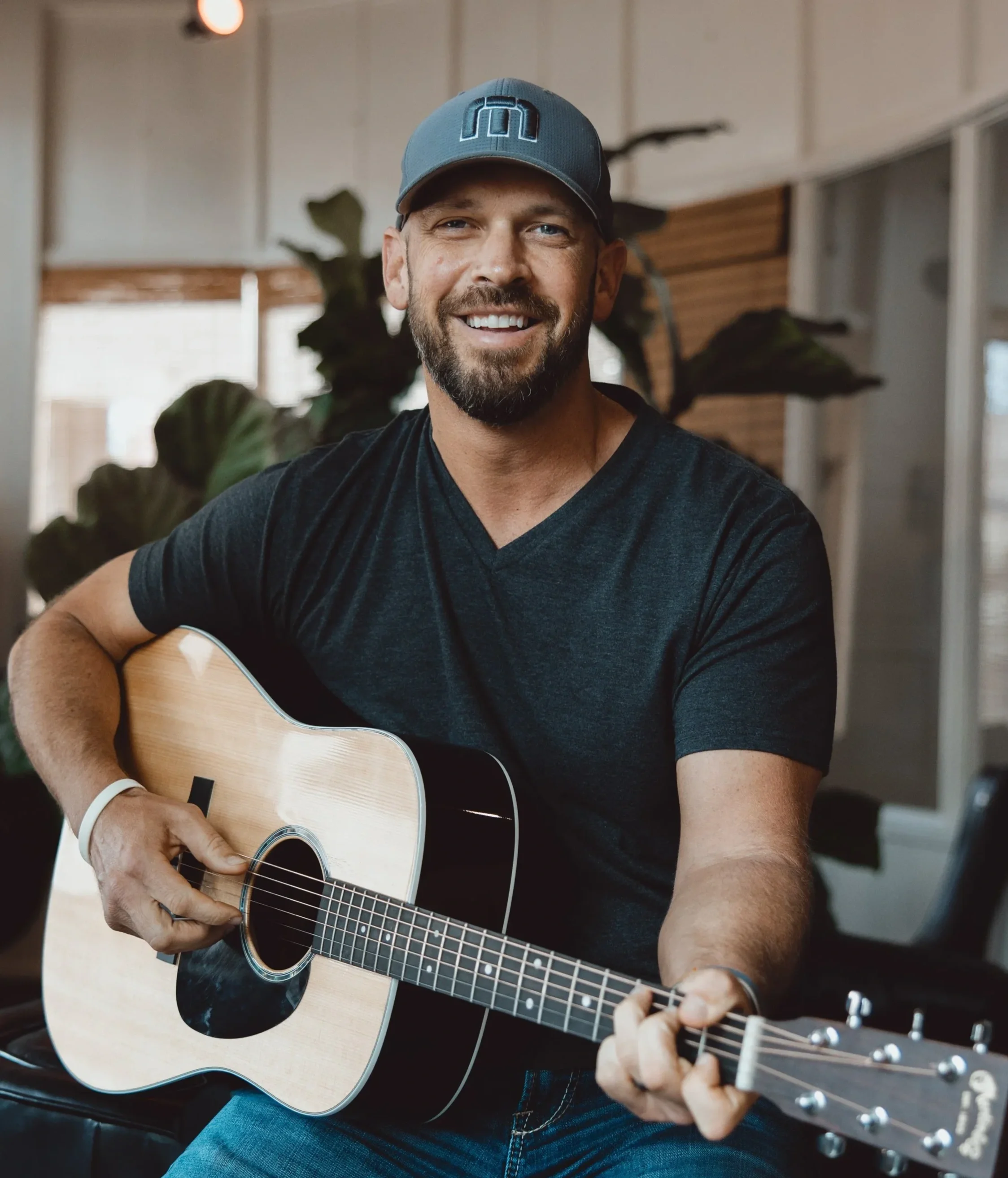 Dustin Becker performing acoustic music indoors