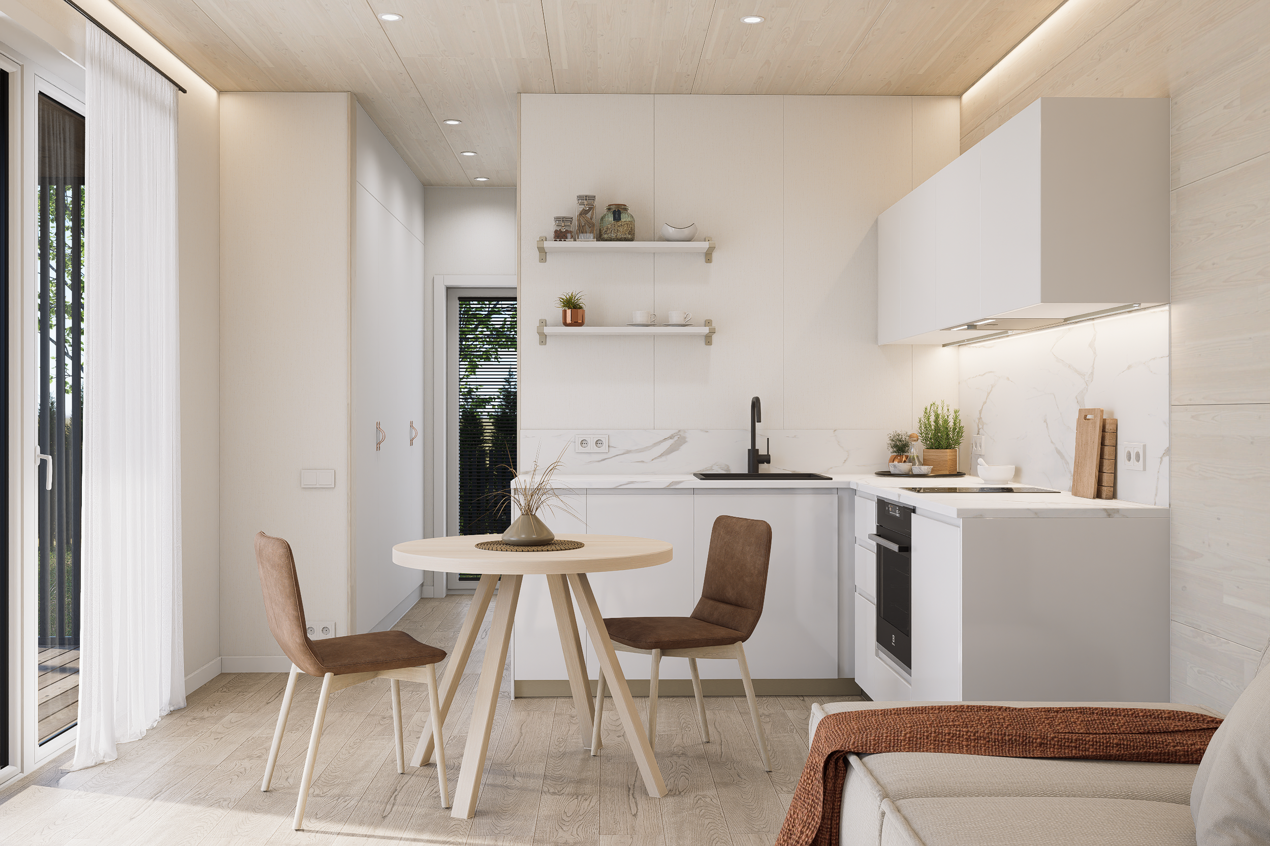 A modern, minimalist kitchen with white cabinetry, a black faucet, and a round wooden dining table with three chairs. The kitchen has a light wood ceiling and floor, with two open floating shelves holding jars and decorative items. There is a potted plant on the table and a sliding glass door with sheer white curtains on the left, leading outside.