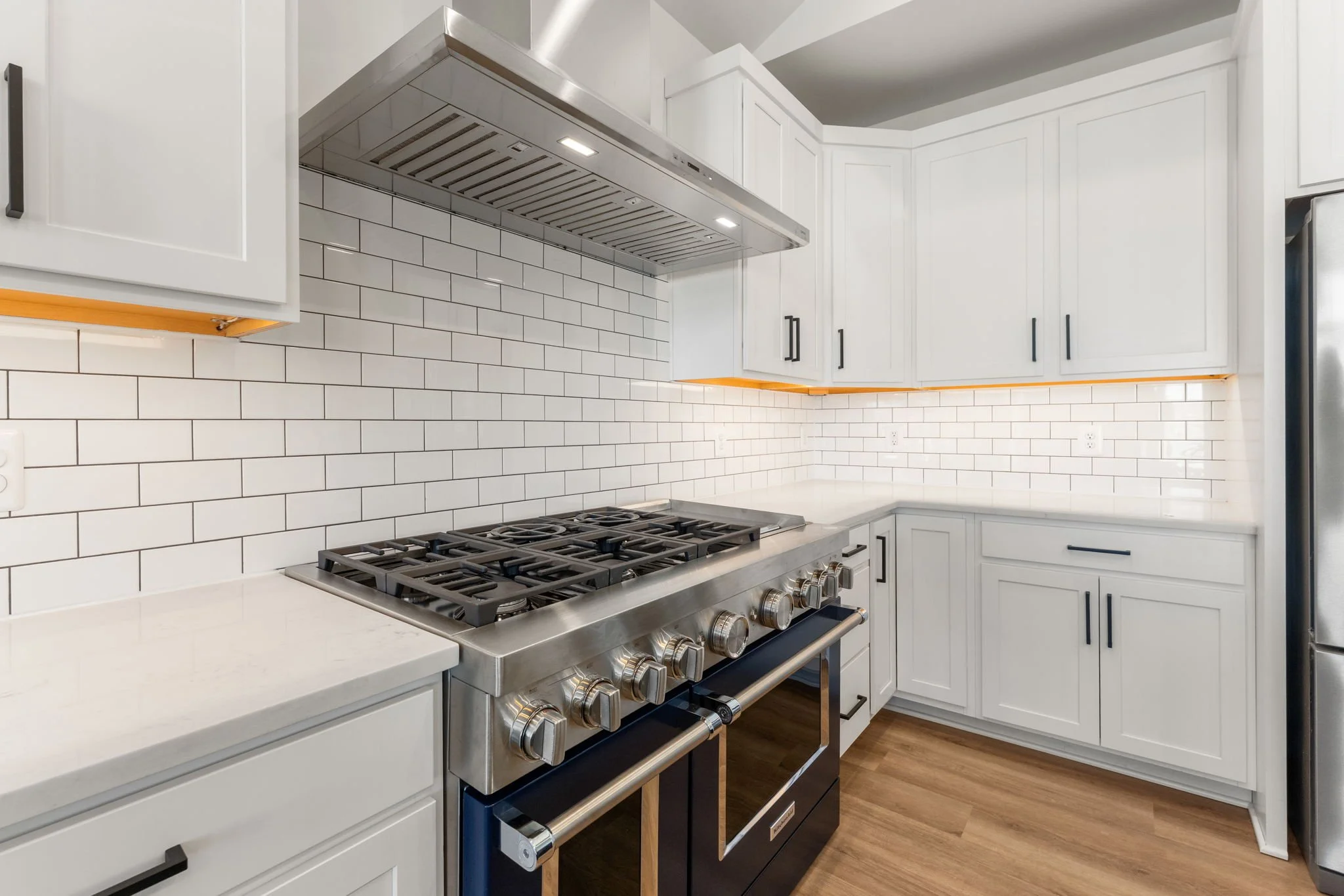 Modern kitchen with stainless steel gas stove.