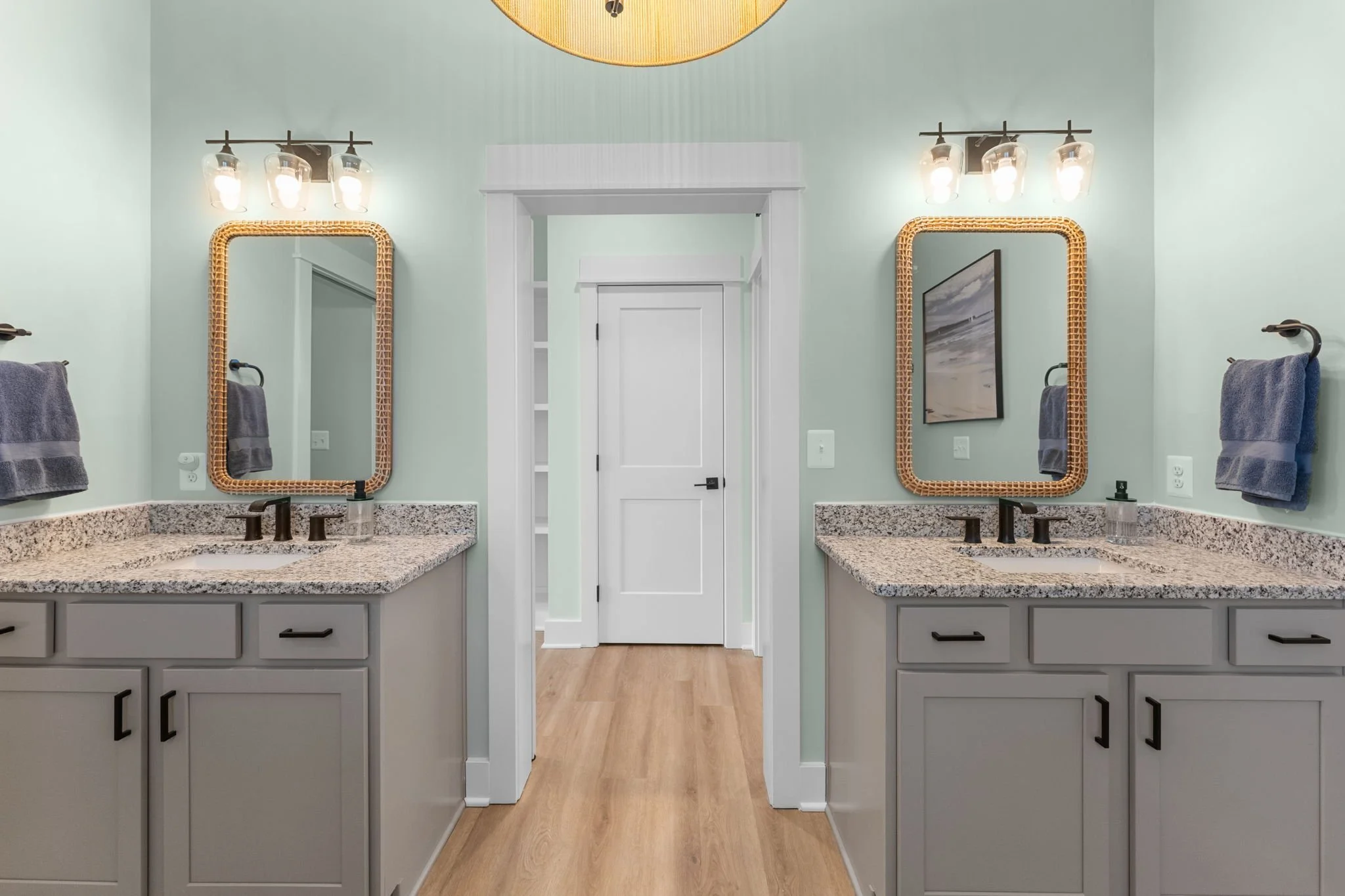 Master bathroom with double vanity, granite countertops, and walls painted sea salt green.