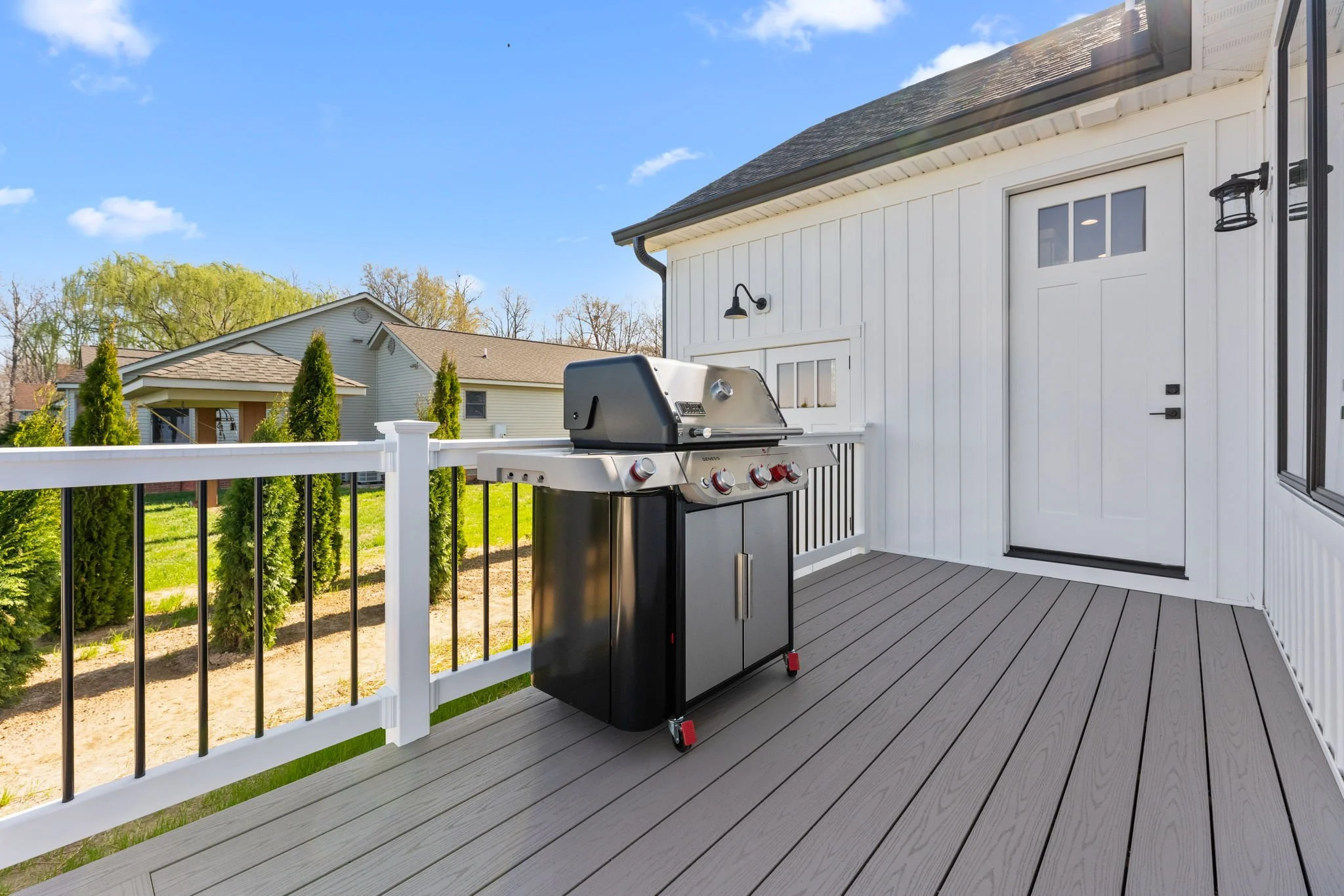 Outdoor deck with a gas grill.