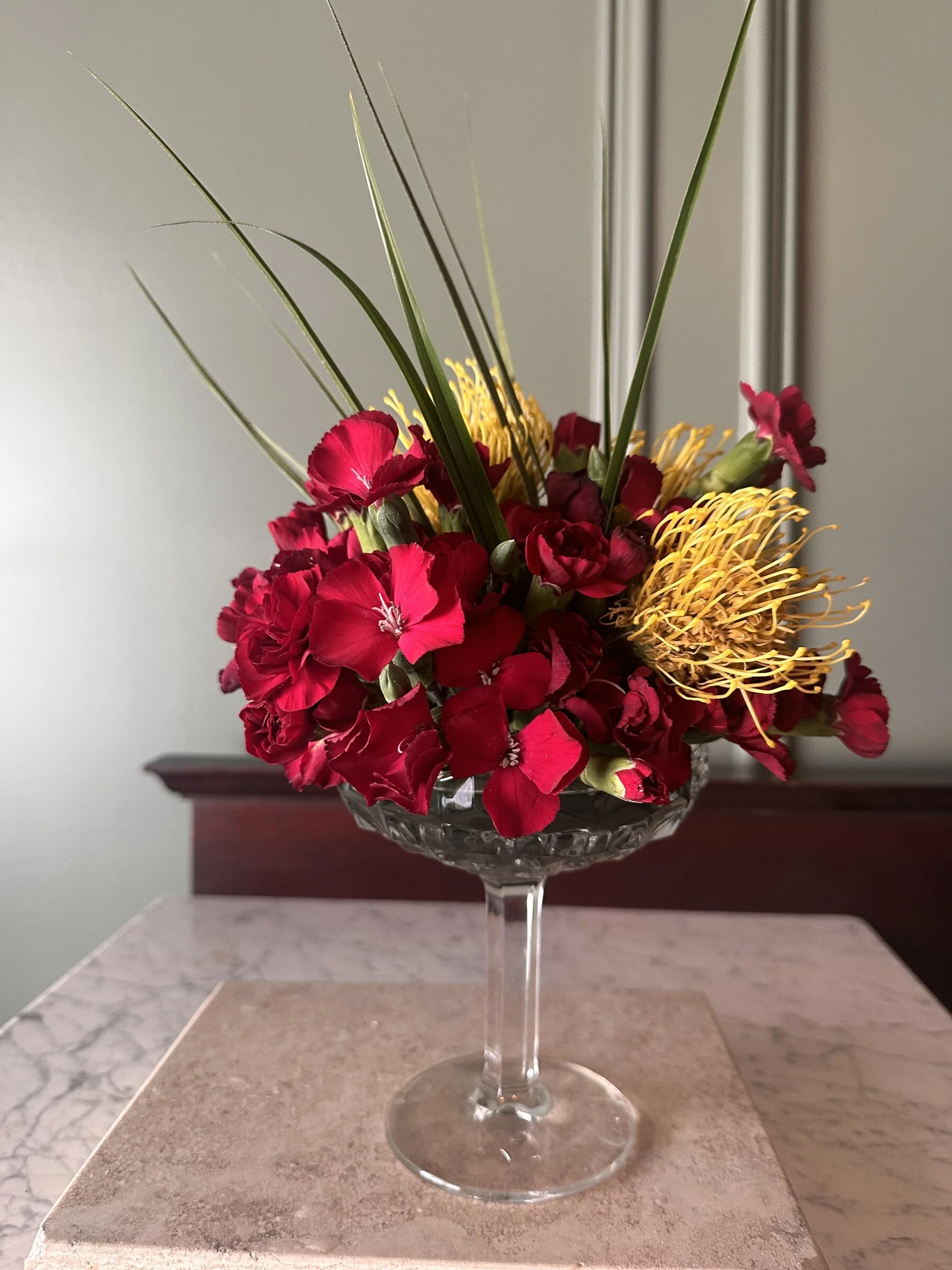 red-dianthus-yellow-pincushion-protea-coupe-arrangement-raleigh-florist.jpg
