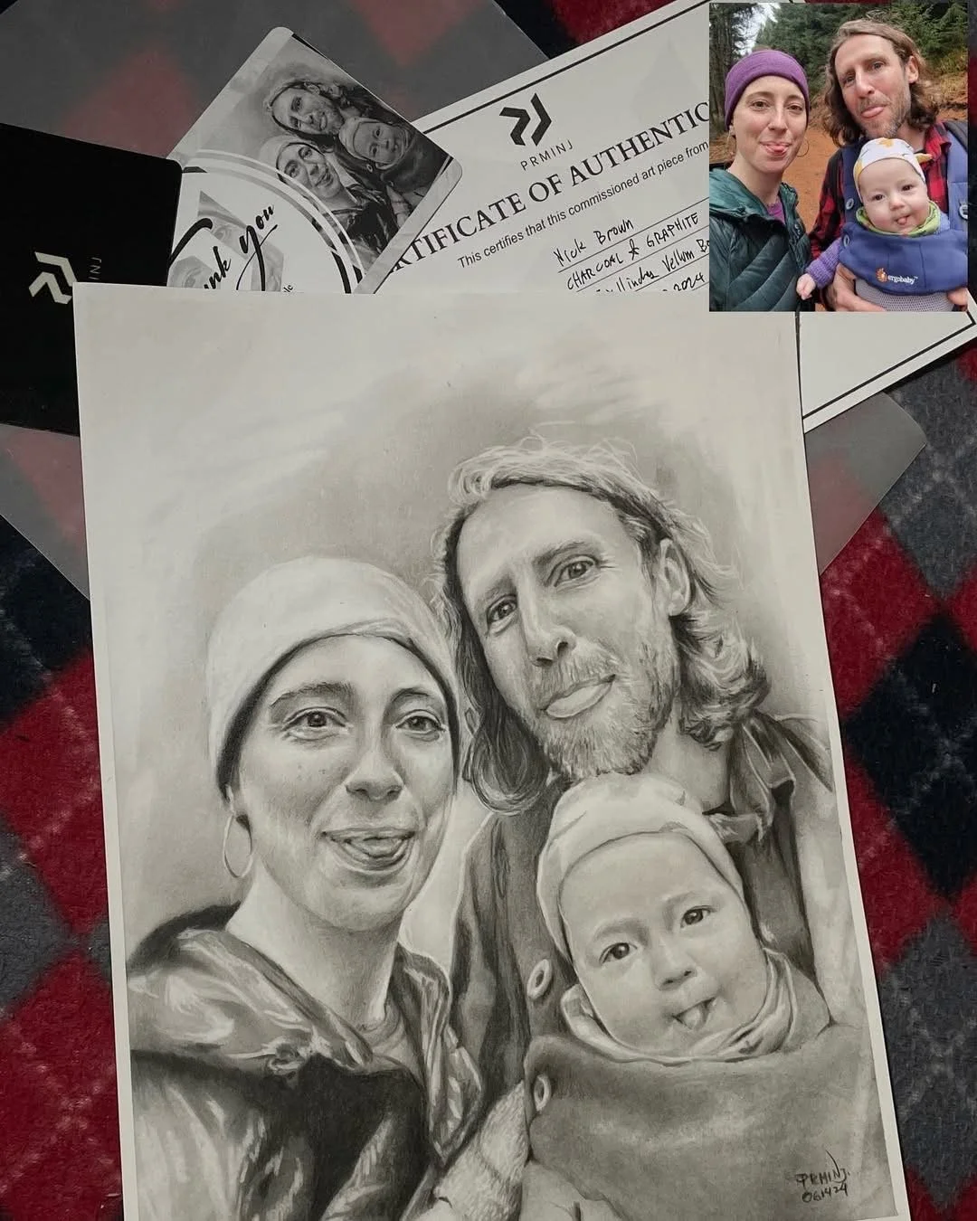 A pencil sketch of a family of four, including a woman, a man, a baby, and a woman in a headscarf, all smiling.