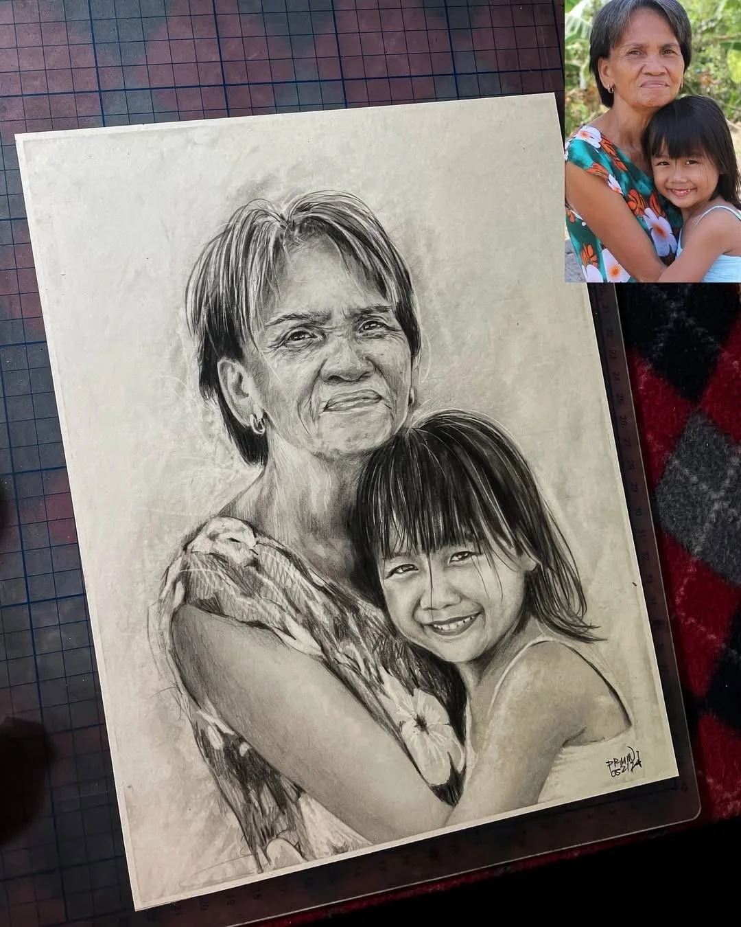 A detailed black-and-white pencil drawing of an elderly woman and a young girl, both smiling and hugging.