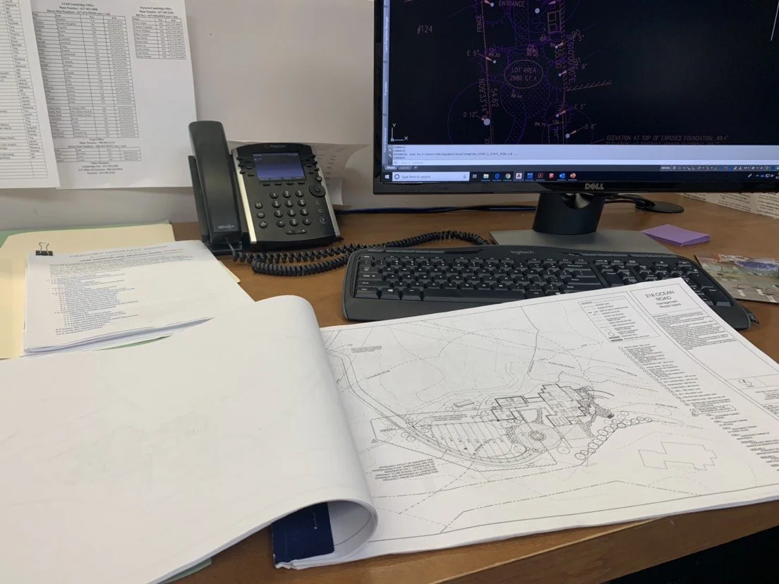 A plan set on a typical design office desk
