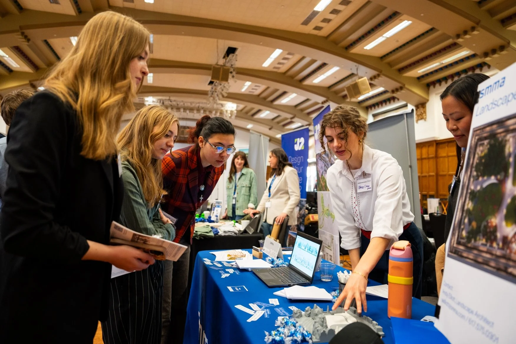students talking to design firms