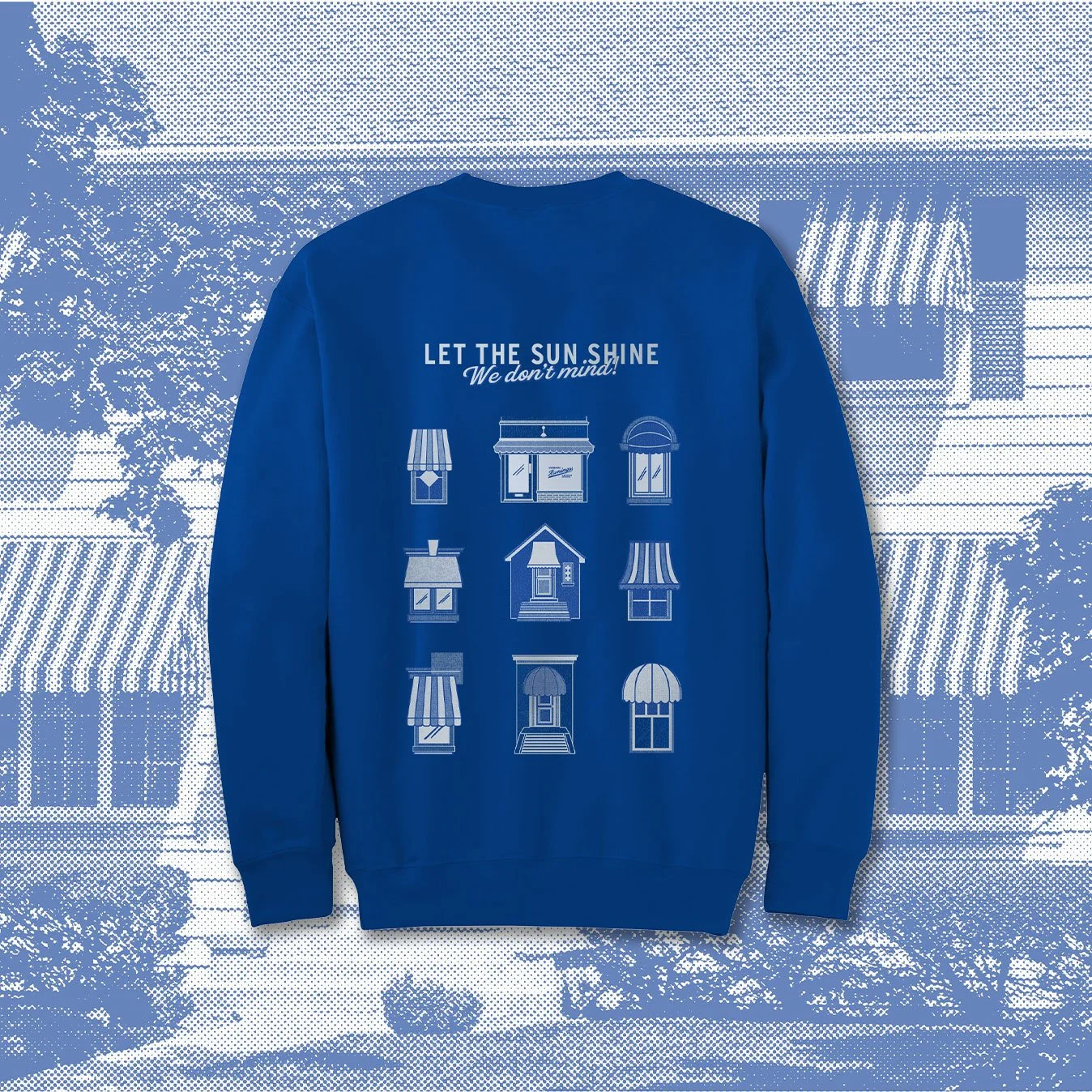 A blue sweatshirt hanging outdoors with white text that says "Let the sunshine, We don't mind!" and illustrations of various window designs on the back.