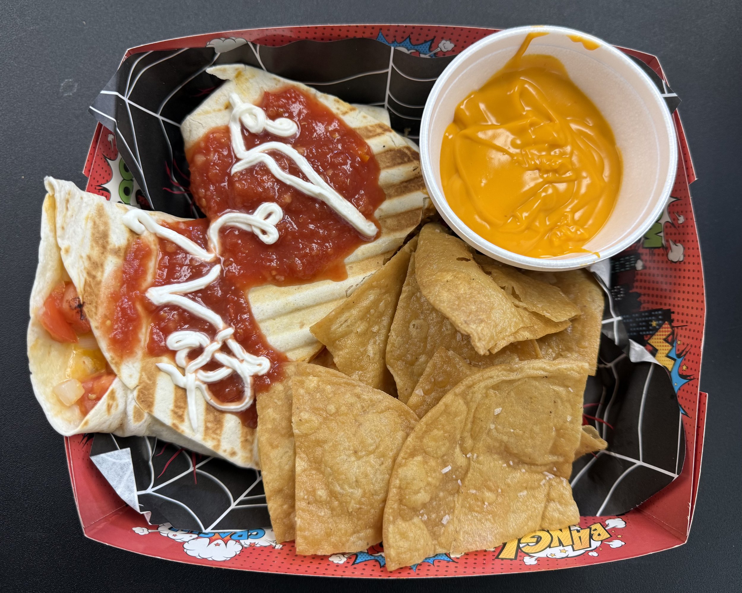 The "Beast Burrito" a pressed tortilla burrito with your choice of meat and toppings, served with chips and queso