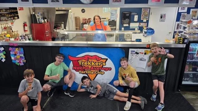 Five boys posing for a picture around the counter inside Trekker's restaurant.