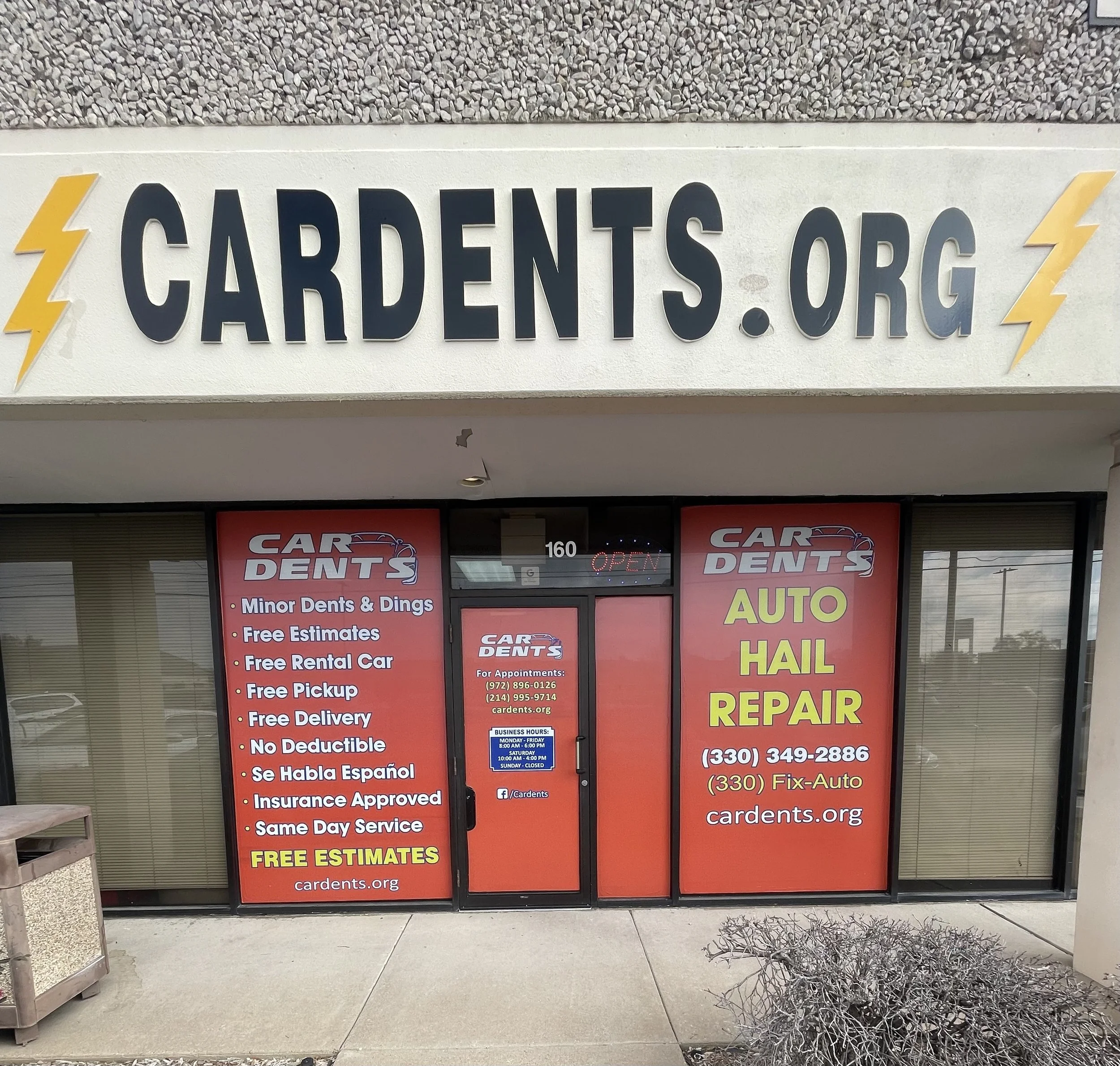 Exterior of a repair shop named CAR DENTS with advertisements for auto hail repair, minor dents, dings, free estimates, free rental cars, and same day service, along with contact information and business hours.