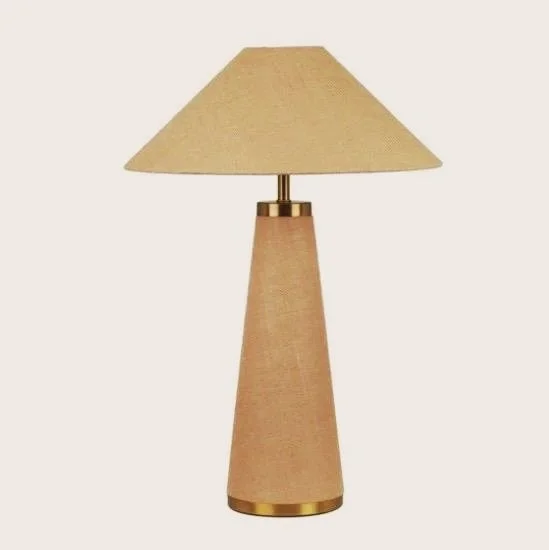 Layer a touch of understated luxury into your space with a sculptural statement lamp wrapped head to toe in richly textured natural jute. Its monochromatic palette and tactile finish reflect that effortless European balance of raw material and refine