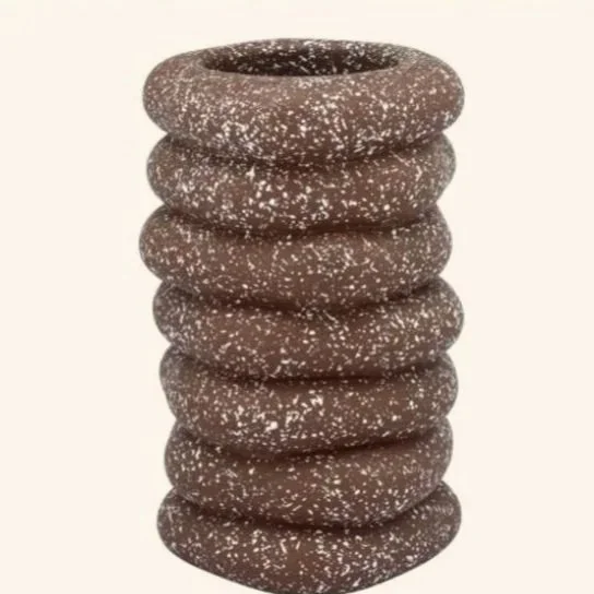 Sculptural rings and a speckled finish brings bold wabi-sabi charm. It carries that quiet European appreciation for imperfection and material honesty, where objects feel shaped by hand, not just design software. The layered silhouette feels at home i