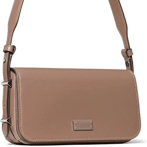 This Kate Spade small East West shoulder bag brings a softer kind of structure to everyday dressing. Its elongated silhouette feels distinctly modern and is 
designed to sit close and carry light. A piece that feels at home in the rhythm of European 