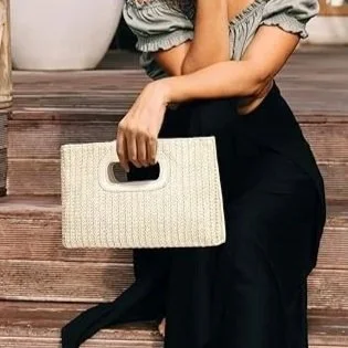 Polished, poised, and made for after hours. This top-handle clutch balances a clean structure with a fluid gold chain, offering just enough versatility without losing its elegance. Carried in hand or worn lightly on the shoulder, it’s the finishing t