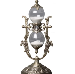 A 15 minute hourglass with an embossed gold finish, part functional object, part vintage curiosity. In an eclectic space, small details like this add texture and a bit of old world charm, giving a shelf or desk something worth pausing on.