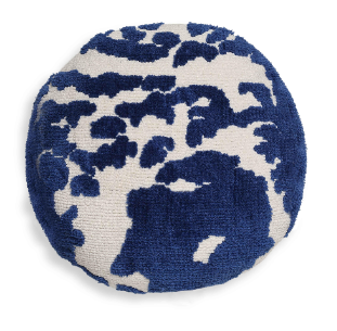 A round, tufted throw pillow that breaks up the usual square shapes scattered through a room, adding an unexpected form to the mix. Eclectic spaces lean on details like this, small shifts in shape and texture that keep a room from feeling too matched