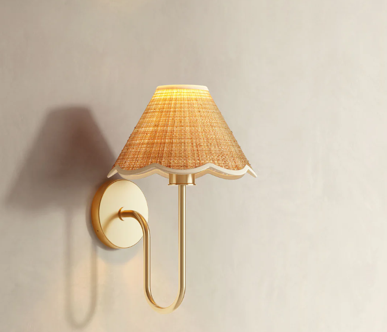 Lyra Clamp Cone Wall Light Sconce
This Rattan Sconce blends a U-shaped brass arm with a graceful scalloped shade. Create an inviting, designer feel in your bedroom or dining room.